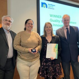 Stacey Stockdale and Rosibel Quintana receiving their award at the Northern Cancer Alliance conference