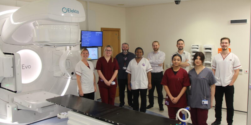 Members of the radiotherapy team with the latest LINAC machine.
