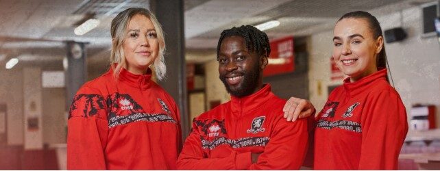 A group of three people advertising the OPTIMISE programme with MFC Foundation