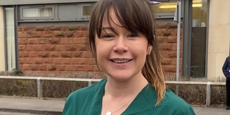 Eilis in her green uniform stood outside James Cook Hospital