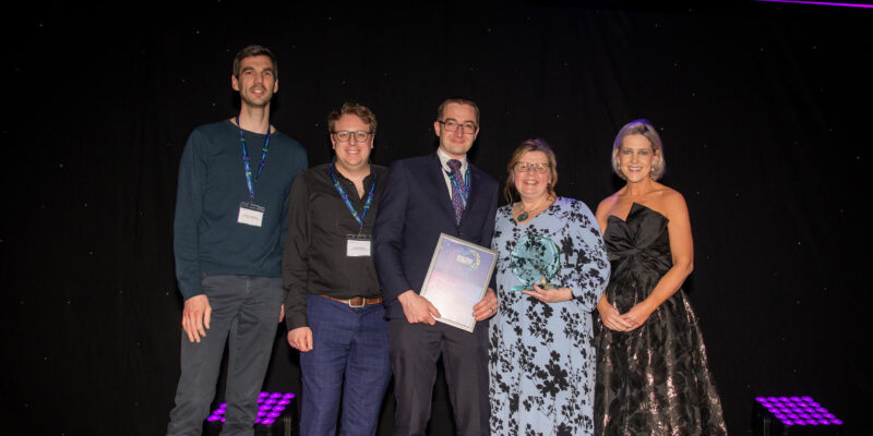 Alistair Levett-Renton, Andrew Simpson, Dave Ferguson, Sharon Brown with presenter Marie Roche, chief operating officer AHSN stood on the stage recieving the award